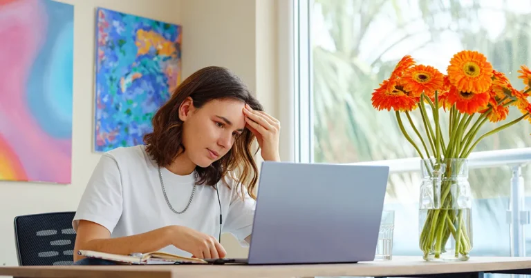 Exhausted professional experiencing burnout symptoms while working late at a desk